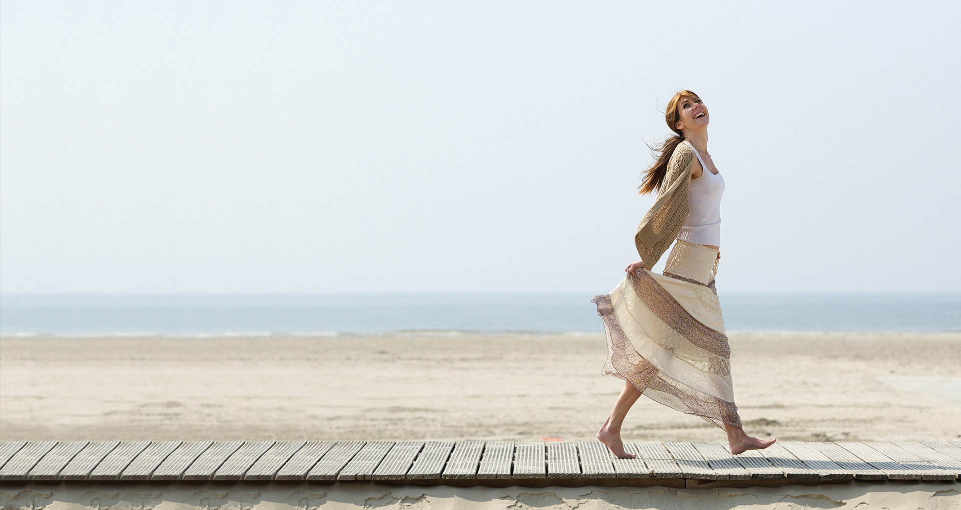 woman-walking-on-deck-near-beach-i-screen